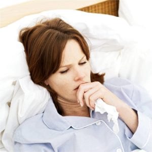 sick woman lying in bed