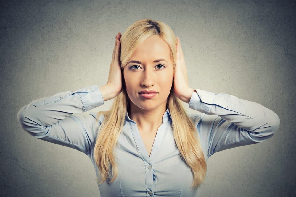 woman blocking her ears