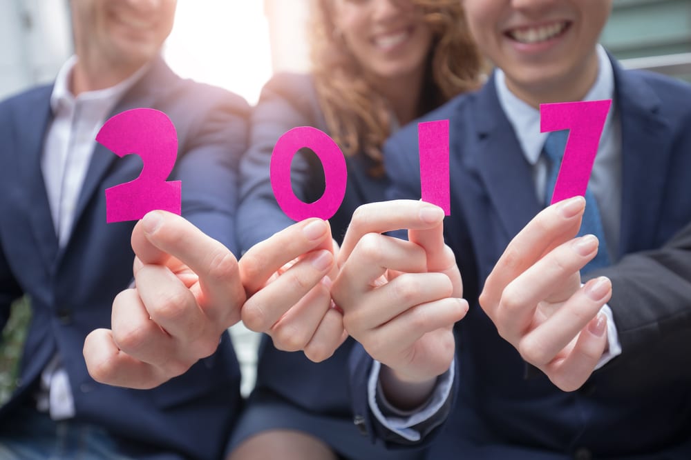 Business people holding 2017 sign