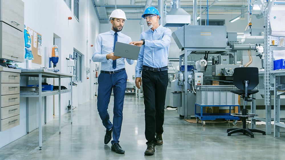 two plant managers ensuring safety on walk through of plant